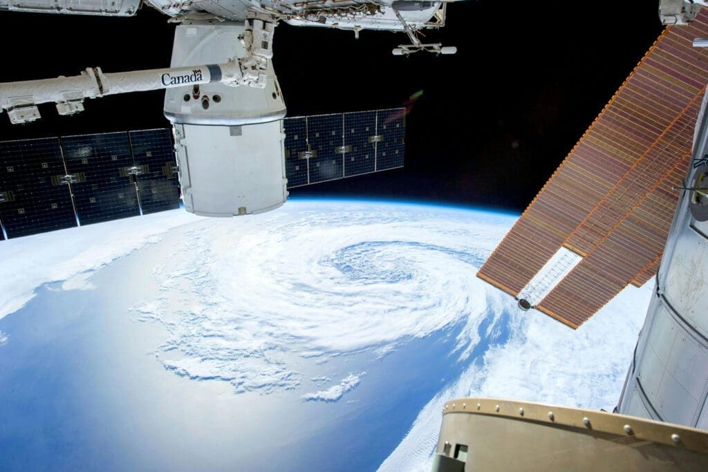 Two satellites with earth in the far background