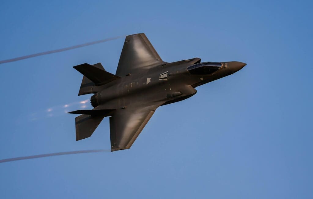 Fighter jet flying on blue sky background